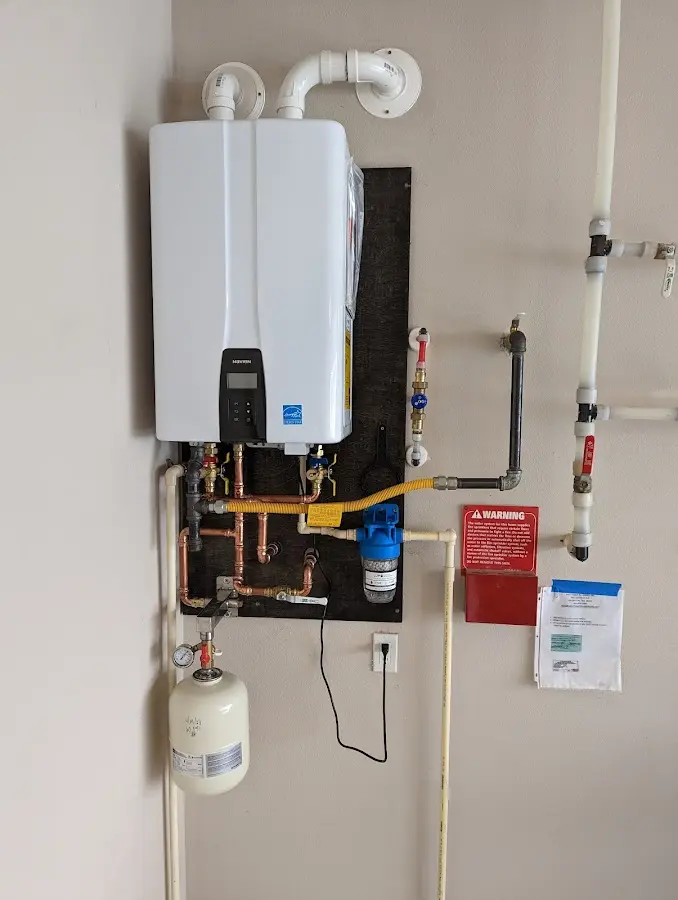 Professional plumber installing copper piping in a Glen Cove home